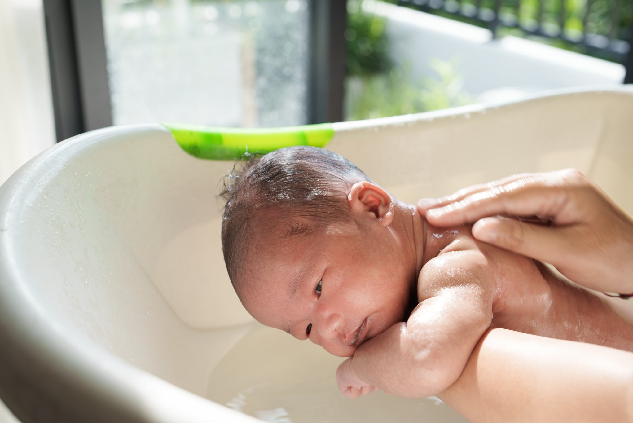 New Born Infant Taking a Bath in the Morning